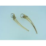 A pair of 14k yellow gold Clip Earrings, the tops set with a large cultured pearl above a long