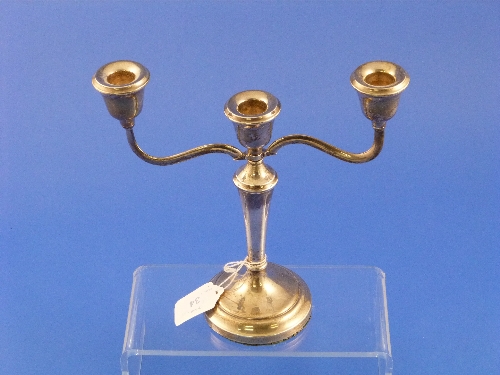 A silver three branch Candelabrum, hallmarked Briminghma, 1968, the circular base with tapering