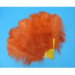 A circa 1920s flamboyantly styled orange ostrich feather Fan, with eight yellow resin sticks/guards,