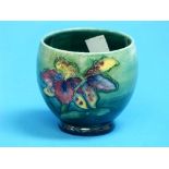 A Moorcroft pottery Orchid pattern Pot, green ground, printed marks on base, 2¾in (7cm) high.