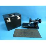 A Vintage 1951 Singer Portable Electric Sewing Machine Model 221K, with rotary hook and