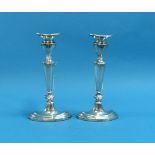 A near matched pair of Elizabeth II silver Candlesticks, hallmarked London, 1967, stepped oval
