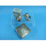 A silver Cigarette Box, hallmarks worn, together with three silver napkin rings, one boxed,