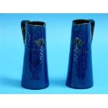 A pair of Honiton pottery blue-ground Jugs, with tube-lined foliate decoration, signed F.H. Honiton,