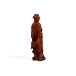 A Chinese boxwood carving of a young lady in trailing robes, late 19th century, standing leaning