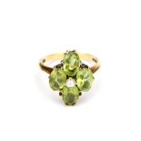 A peridot cluster ring, With half-pearl centre, mounted in 9ct gold, UK hallmark, ring size L