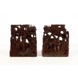 A pair of antique Chinese export hardwood bookends, circa 1900, both frieze carved in high relief,