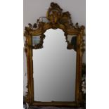A large giltwood Rococo style mirror, with acanthus scroll moulding and floral swags, 172 x 98cm (