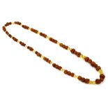 An Oriental ladies bead necklace, 20th century, possibly Indian, each bead carved from walnut with