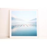 A large white framed photograph picture of water and mountains by Tim Hall, 150 x 150cm (incl.