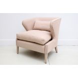 A Finchatton tub armchair, upholstered in pink linen.