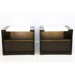 A pair of bedside tables, with white lacquered central panels and cupboards with drawers underneath,