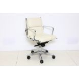 A Luxy Eames design chrome and white leather desk armchair.