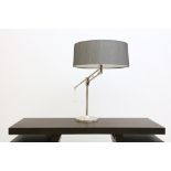 An adjustable chrome table lamp. Shades by Arteriors.