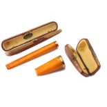 Two George V 9 carat gold mounted amber cheroot / cigarillo holders The cigarillo holder marked