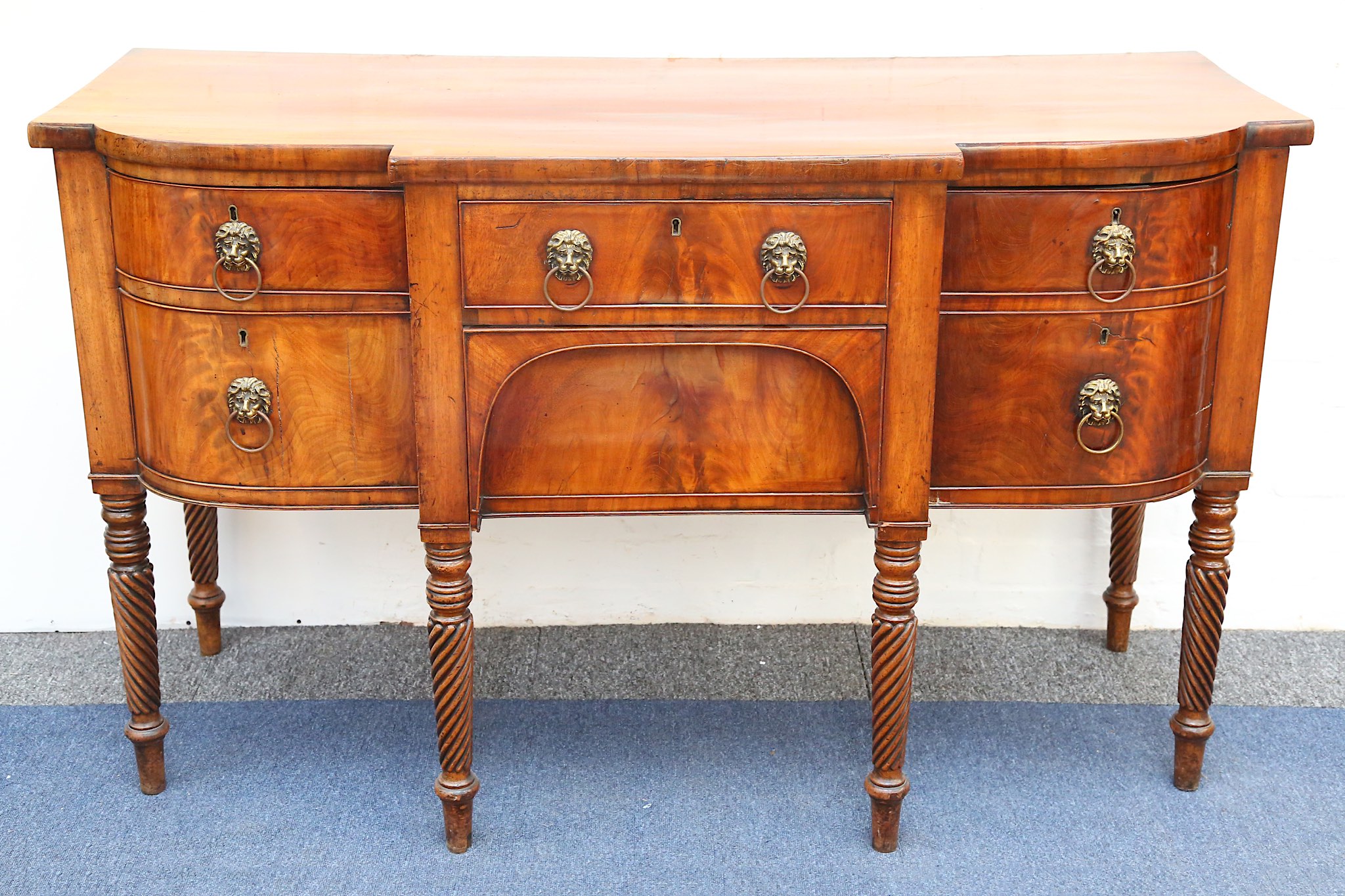 A late Regency mahogany breakfront sideboard, early 19th century, fitted with two central drawers