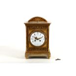 A French gilt bronze mounted alabaster mantel clock, 19th Century, the floral tablet, paterae column