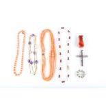 A small group of jewellery, including four gem-set necklaces, an amethyst cross, a brooch and an