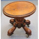 A small Victorian oval mahogany table, 19th Century, with a raised half-edge set onto a heavily
