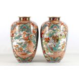 A pair of Japanese porcelain baluster vases, Meiji period, decorated with panels of Immortals and