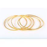 A set of bangles, four with star motif designs, two stamped 22K, misshapen (5)