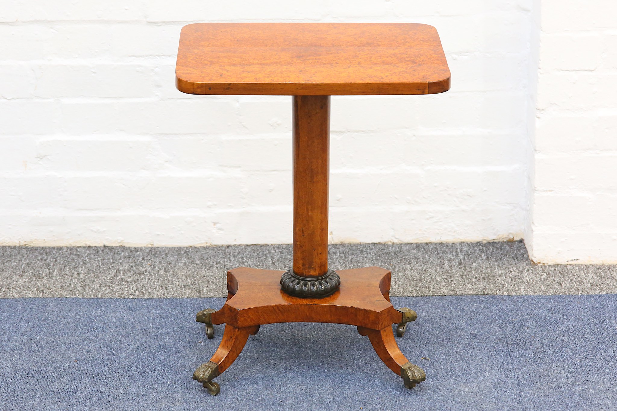 A small George IV style rectangular amboyna side table, early 19th Century, on a tapered cylindrical