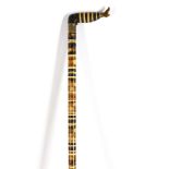 A Victorian bone, ebony and horn disc walking stick, 19th century, the handle modelled as a leg