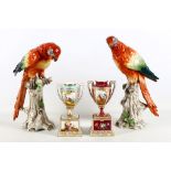 A pair of Sitzendorf porcelain figures of Parakeets, early 20th century, modelled perched on