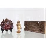 A collection of Southeast Asian items, comprising a wooden panel of a reclining Buddha, a Tibetan