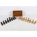 A boxwood and stained ebony chess set, early 20th Century, in its original presentation box, the