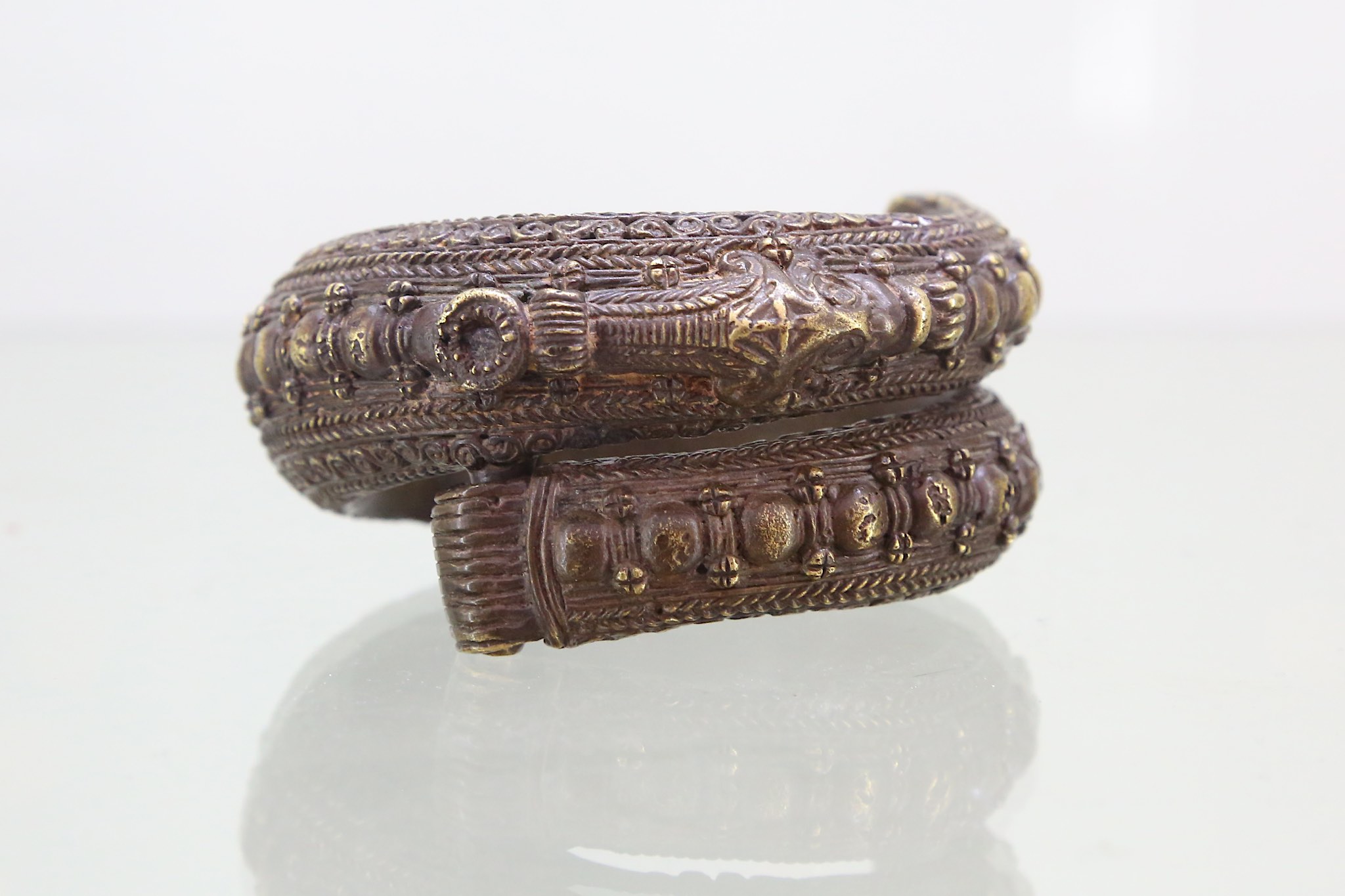 A copper Toba Batak bangle, Sumatra, Indonesia, late 19th to early 20th Century, of circular form,