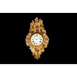 A LARGE EARLY 20TH CENTURY GEORGE III STYLE GILTWOOD CARTEL CLOCK the case of Rococo design with