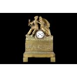 AN EARLY 19TH CENTURY FRENCH EMPIRE PERIOD GILT BRONZE FIGURAL MANTEL CLOCK WITH A COURTING COUPLE