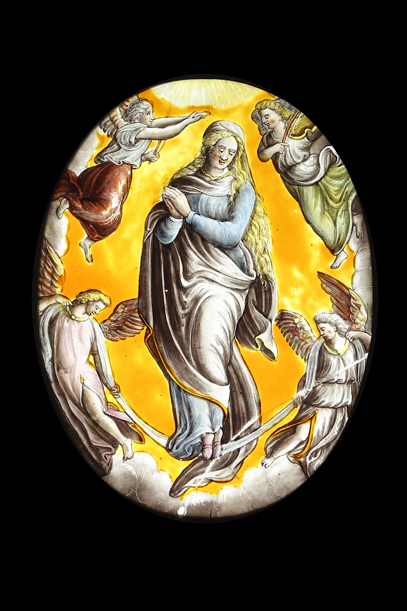 A 16TH CENTURY STAINED GLASS PANEL DEPICTING THE ASSUMPTION OF THE VIRGIN of oval form, the Virgin