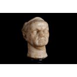 A SMALL 17TH CENTURY MARBLE HEAD OF JULIUS CAESAR, PROBABLY GERMAN the Roman Emperor depicted