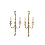 A PAIR OF LOUIS XVI STYLE BRONZE WALL LIGHTS the backplates modelled as tasselled ribbons, each