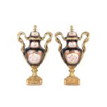 A PAIR OF LOUIS XV STYLE PORCELAIN AND GILT BRONZE MOUNTED VASES AND COVERS in the Sevres style, the