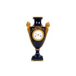 A LOUIS XVI STYLE PORCELAIN AND GILT BRONZE MOUNTED URN CLOCK SIGNED MICHEL A STRASBOURG the