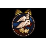 A STAINED GLASS PANEL DEPICTING THE PELICAN IN HER PIETY, PROBABLY 17TH CENTURY of circular form