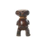 A PYGMY FIGURE, CAMEROON Carved from wood with a dark lustrous patina, the figure stands on squat