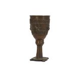 A BRONZE GOBLET  The large goblet stands on a circular base with four lion feet, the bowl is