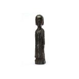 A WOOD FIGURE OF A WOMAN  With a cylindrical stylised body, she wears a dress draped over one