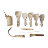 A GROUP OF INUIT ITEMS  Including five scrimshaw walrus ivory or bone spoons, four of which with