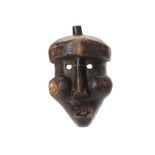 A WOOD MASK, MALI An unusual mask with small hollow circular eyes, bulging cheeks, an elongated nose