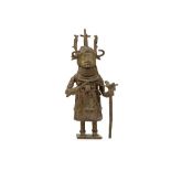 A BRONZE BENIN FIGURE OF AN OBA Standing on an integral square base the figure of the Oba, the ruler