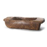 AN AFRICAN SERVING BOWL A large wood tough shaped dish, with a hollow rectangular section and two