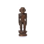 A WOOD FIGURE The figure stands on an integral wood stepped base, with a muscular body, a highly