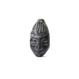 A STONE HEAD, CENTRAL AMERICA Carved in mottled grey stone with a shiny patina, the head wears a