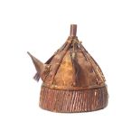 A CEREMONIAL CHIEFTAIN'S HEADDRESS, SOUTHEAST ASIA Of domed form with the cap made of leather,