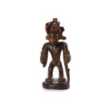 A CHOKWE WOOD FIGURE OF A CHIEF Otherwise known as Mwanangana, the chief is depicted with enlarged